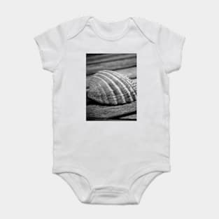 Half a sea shell on wood Baby Bodysuit